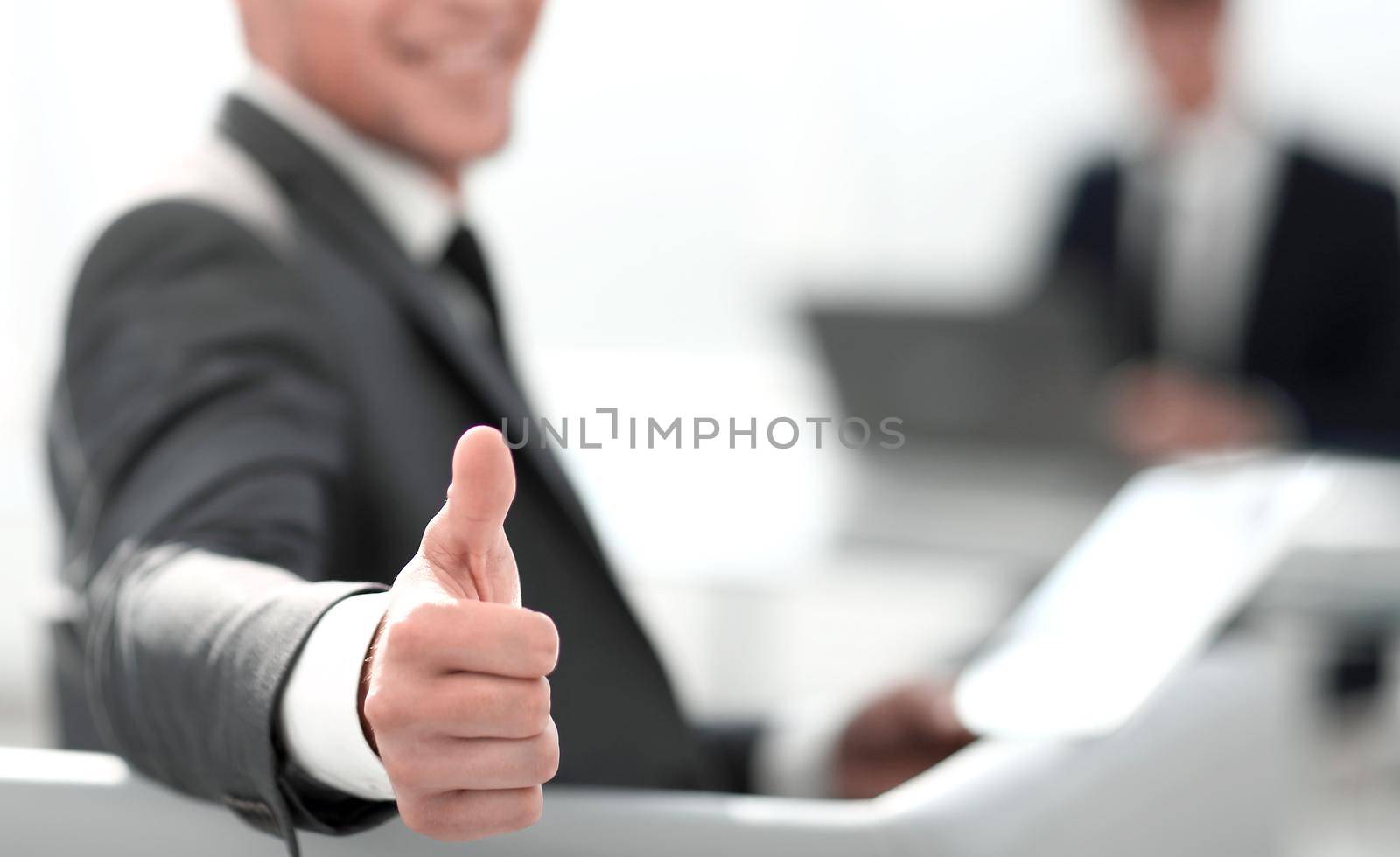 businessman shows thumb up by asdf
