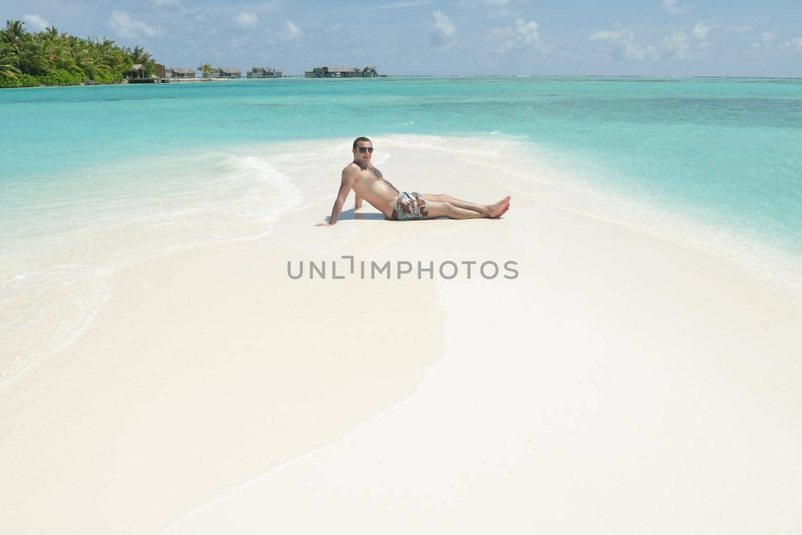 young man have fun and relax on beach by dotshock
