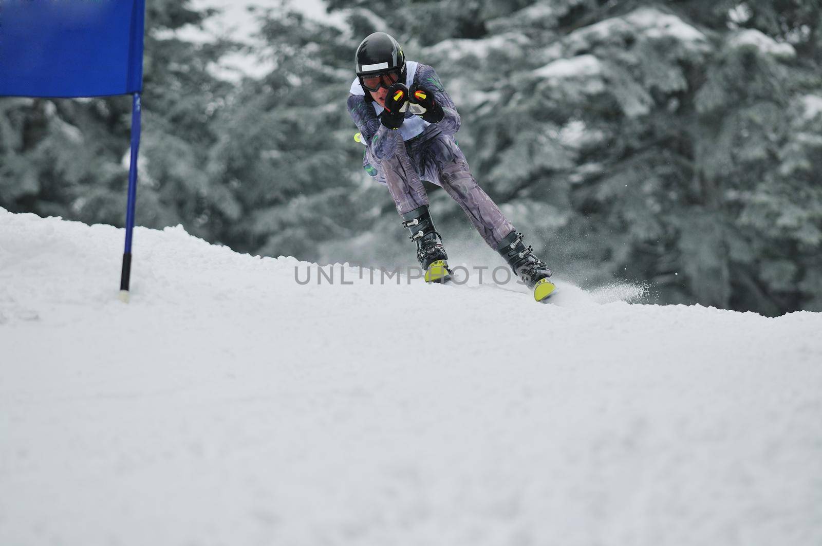 young skier race fast downhil at winter snow scene 