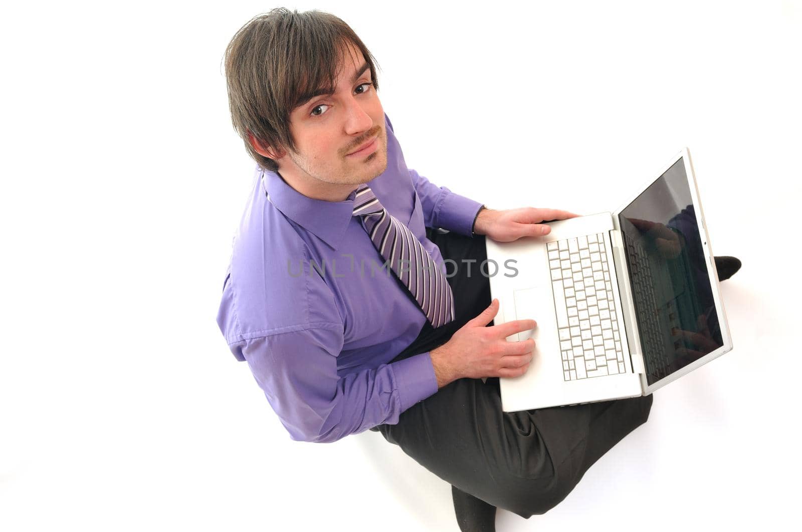 young business man in pink work on laptop isolated