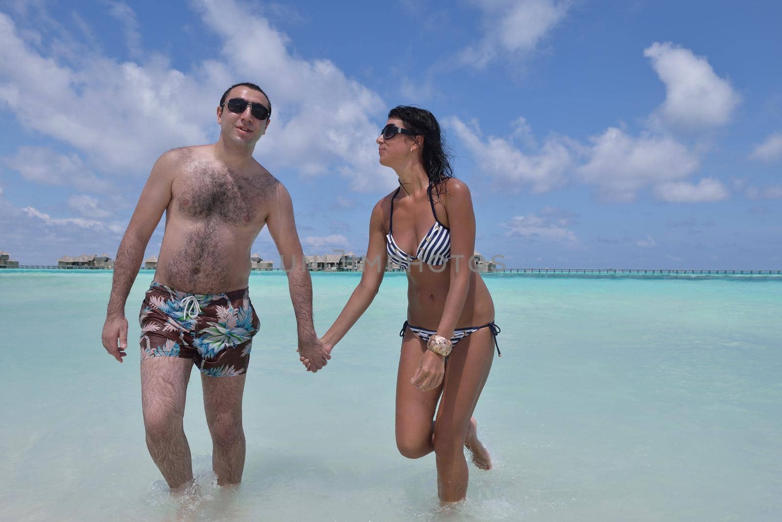 happy young romantic couple in love have fun and relaxing on beautiful beach