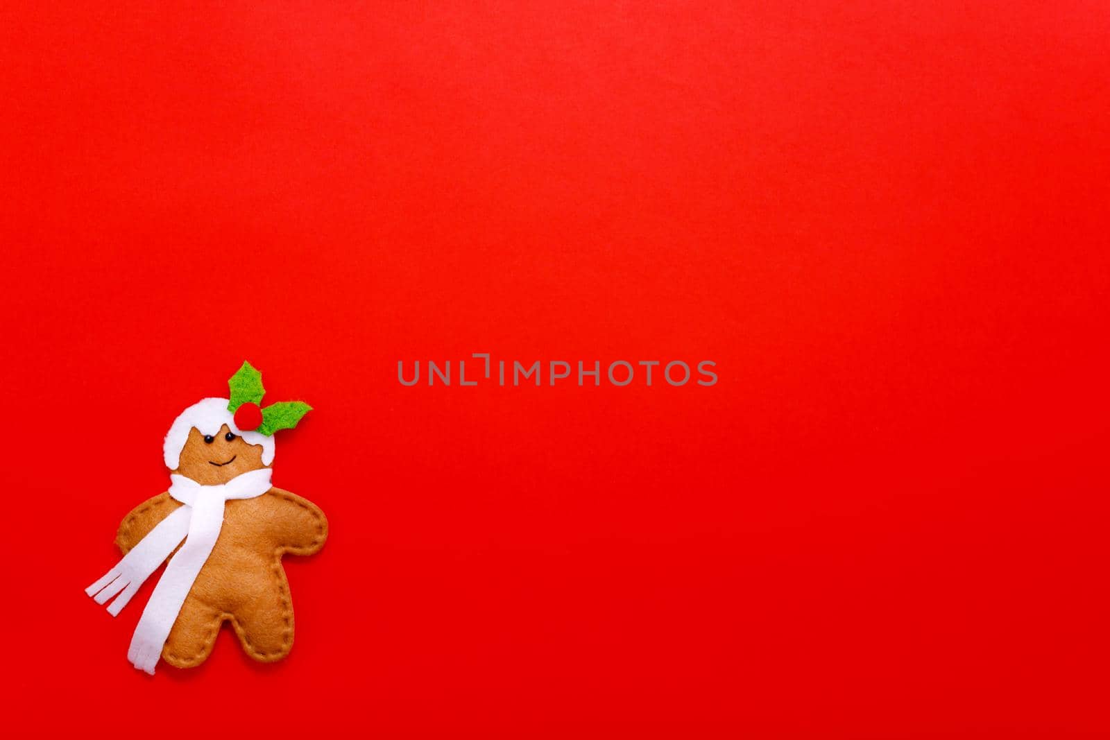 Gingerbread man on a red background. Holiday concept. Christmas background by lifesummerlin