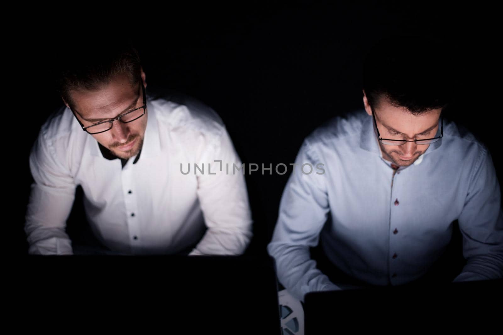 close up.two colleagues working on computers by asdf