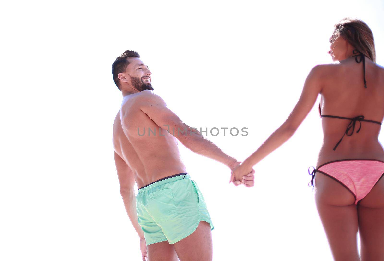 Attractive Fit Couple on the Beach in Swimwear Holding Hands. by asdf