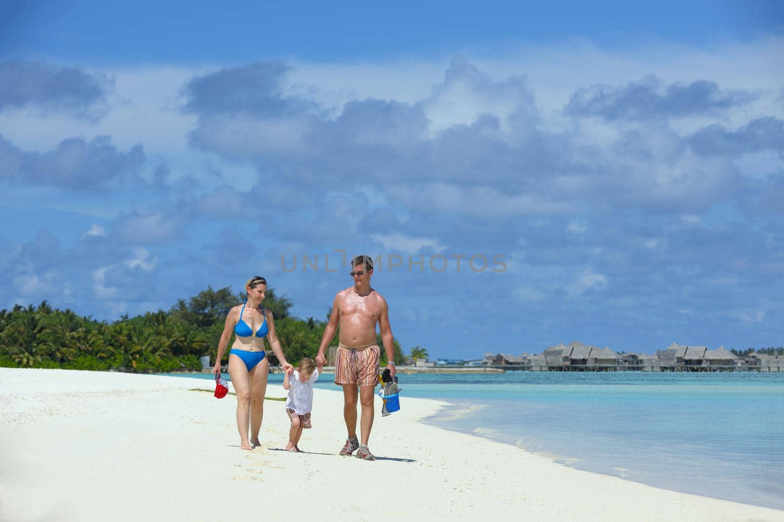 Portrait of a happy family on summer vacation  at beach