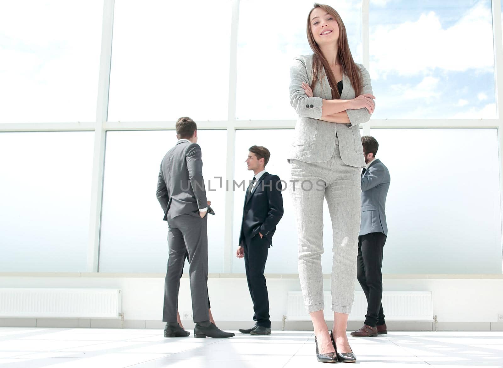 bottom view.confident young business woman standing in spacious lobby by asdf