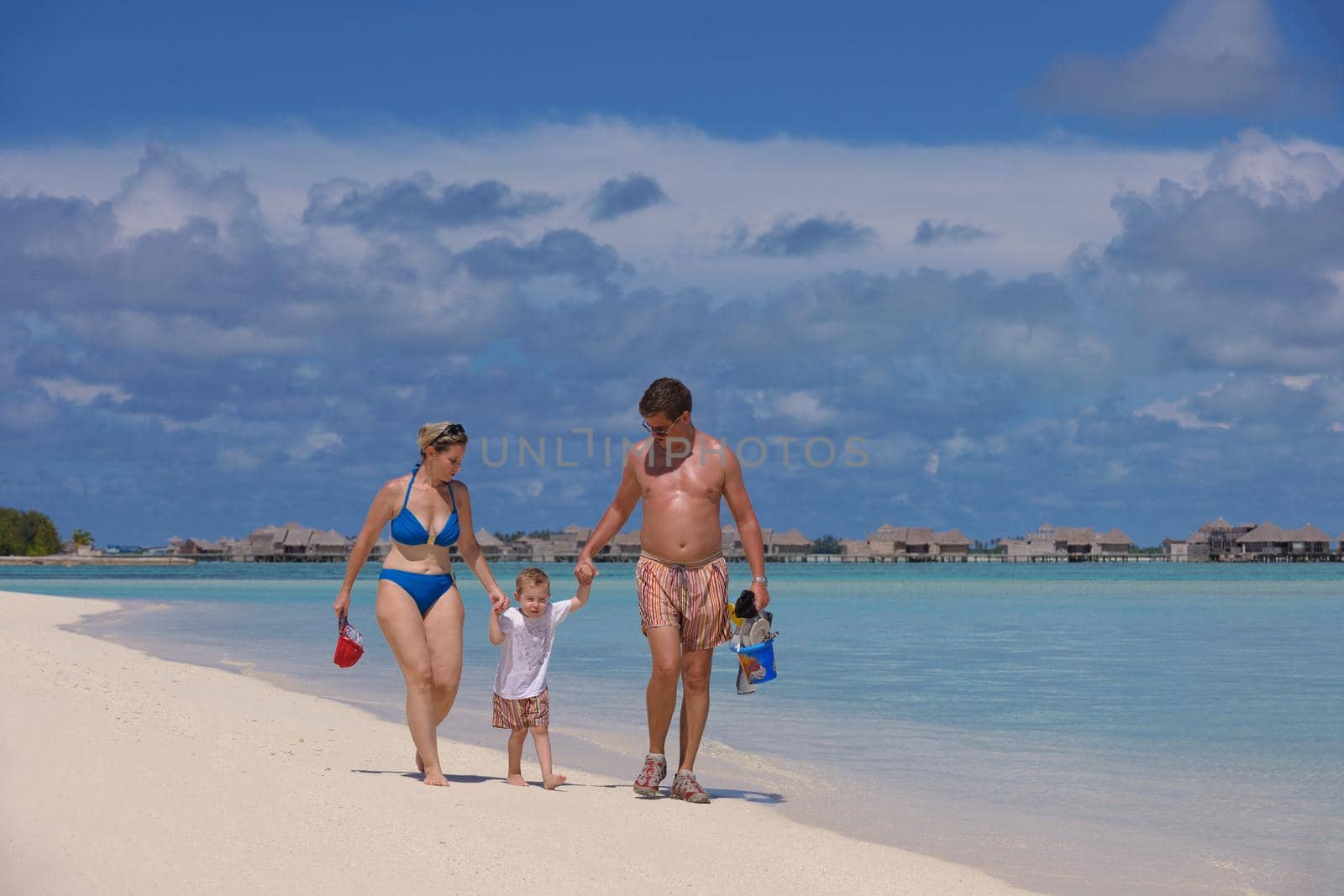 Portrait of a happy family on summer vacation  at beach