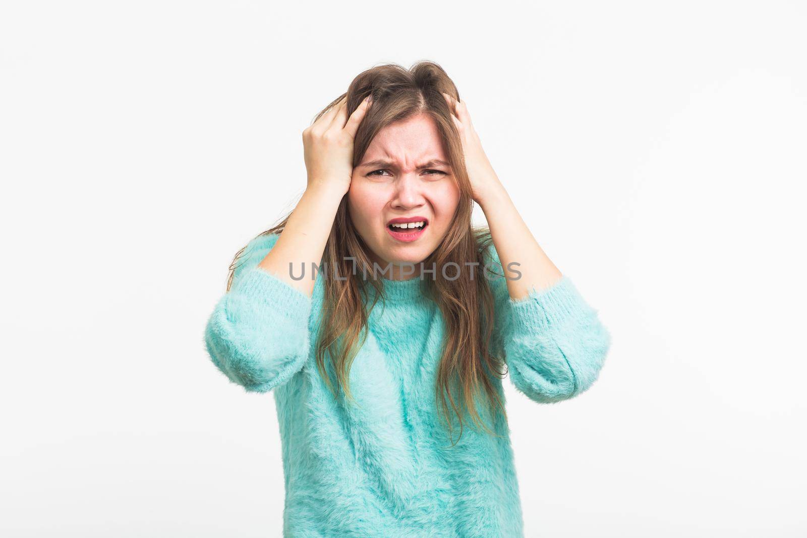 Concerned scared woman on white background in studio