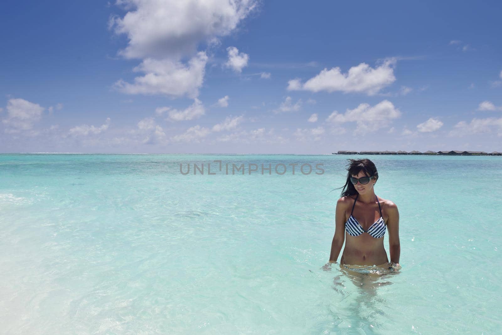 beautiful and happy young woman on beach have fun and relax on summer vacation  over the crystal clear sea