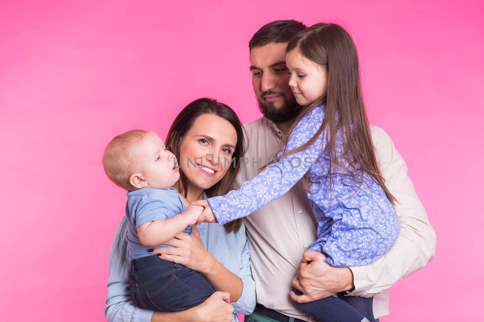 Portrait of Young Happy Mixed Race Family over pink background by Satura86
