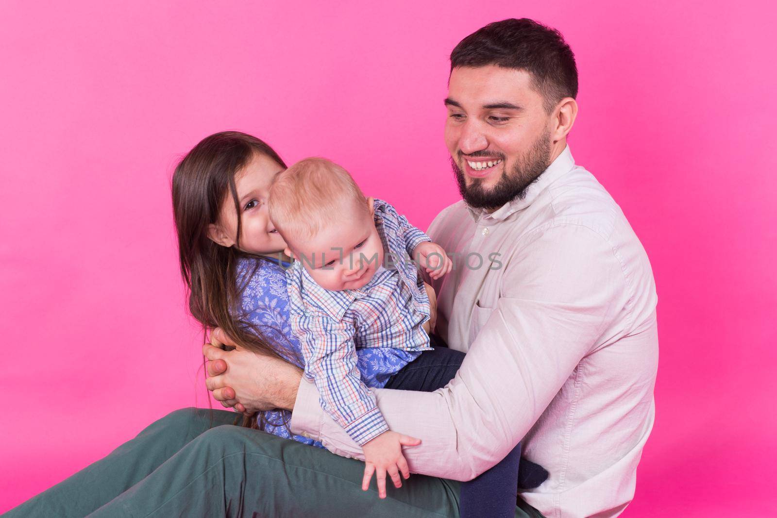 Father with children having fun on pink background by Satura86