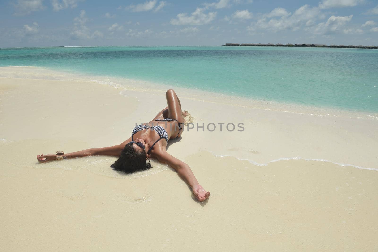 beautiful young woman  on beach have fun and relax by dotshock