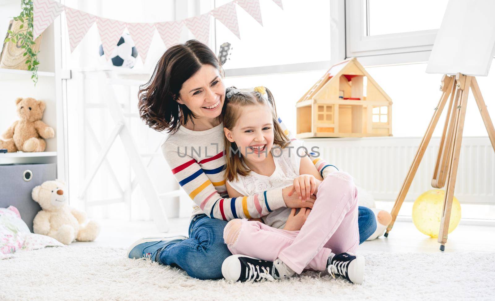 Happy mother with daughter having fun by GekaSkr