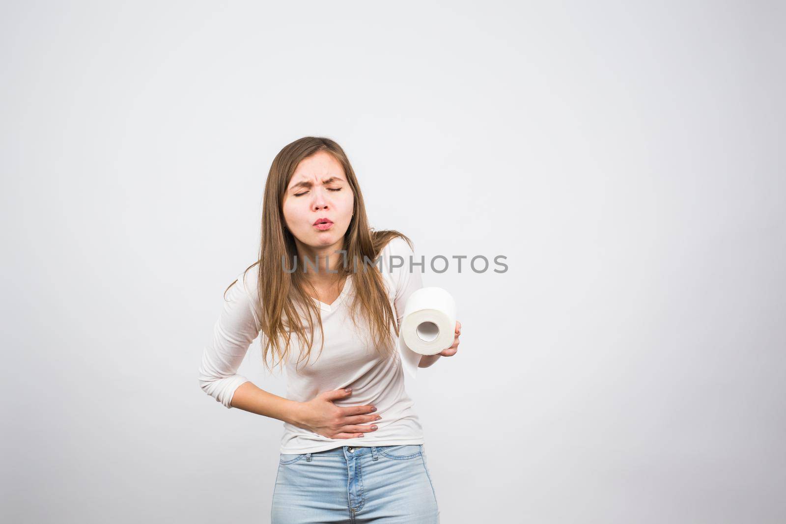 Woman with toilet paper and problems with her digestive system.