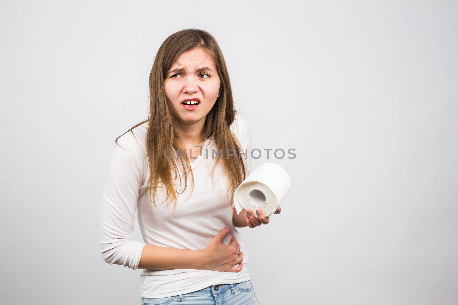 Young woman with Toilet Paper on the White Background - health problem concept by Satura86
