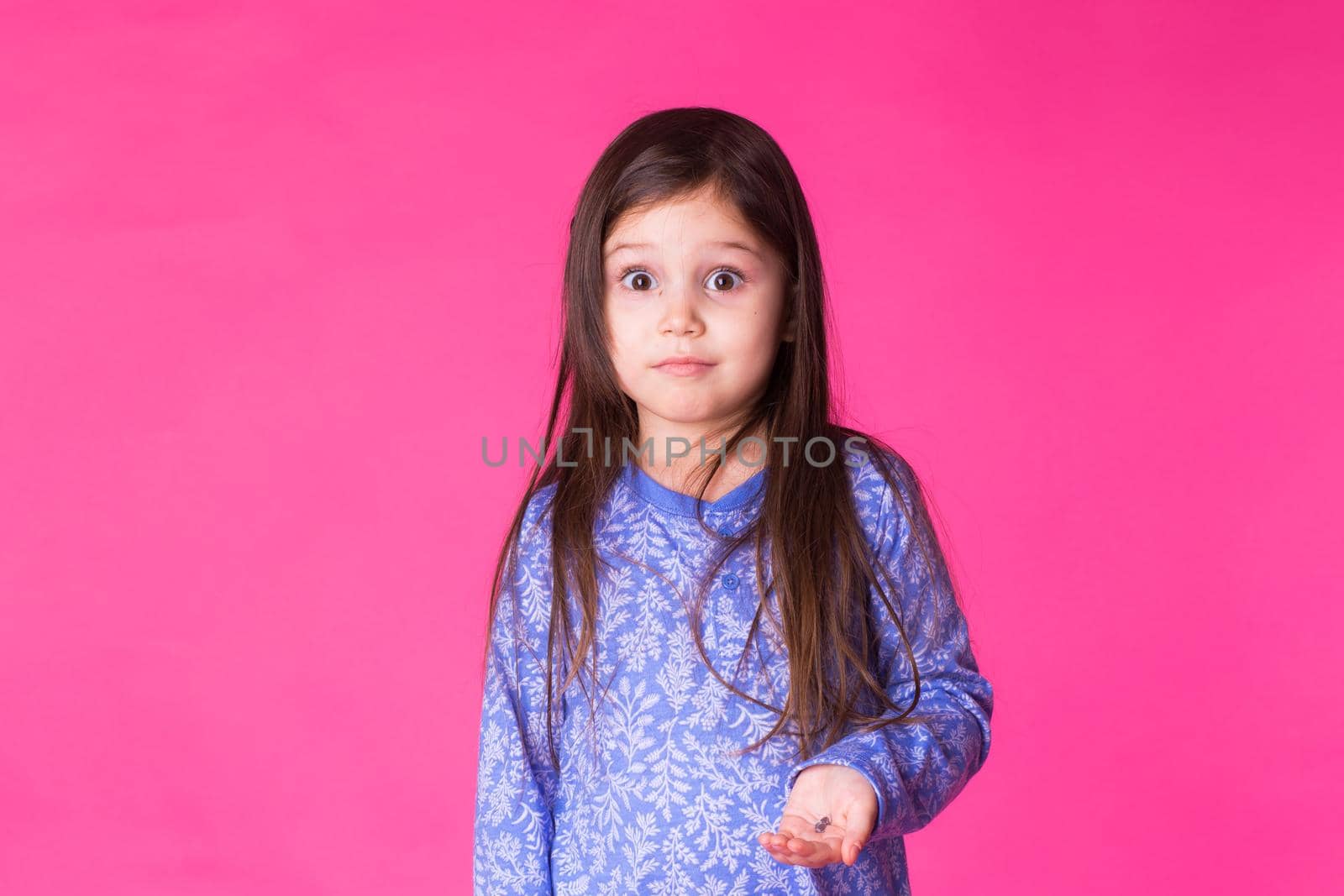 Portrait of a charming brunette little child girl, isolated on pink background by Satura86