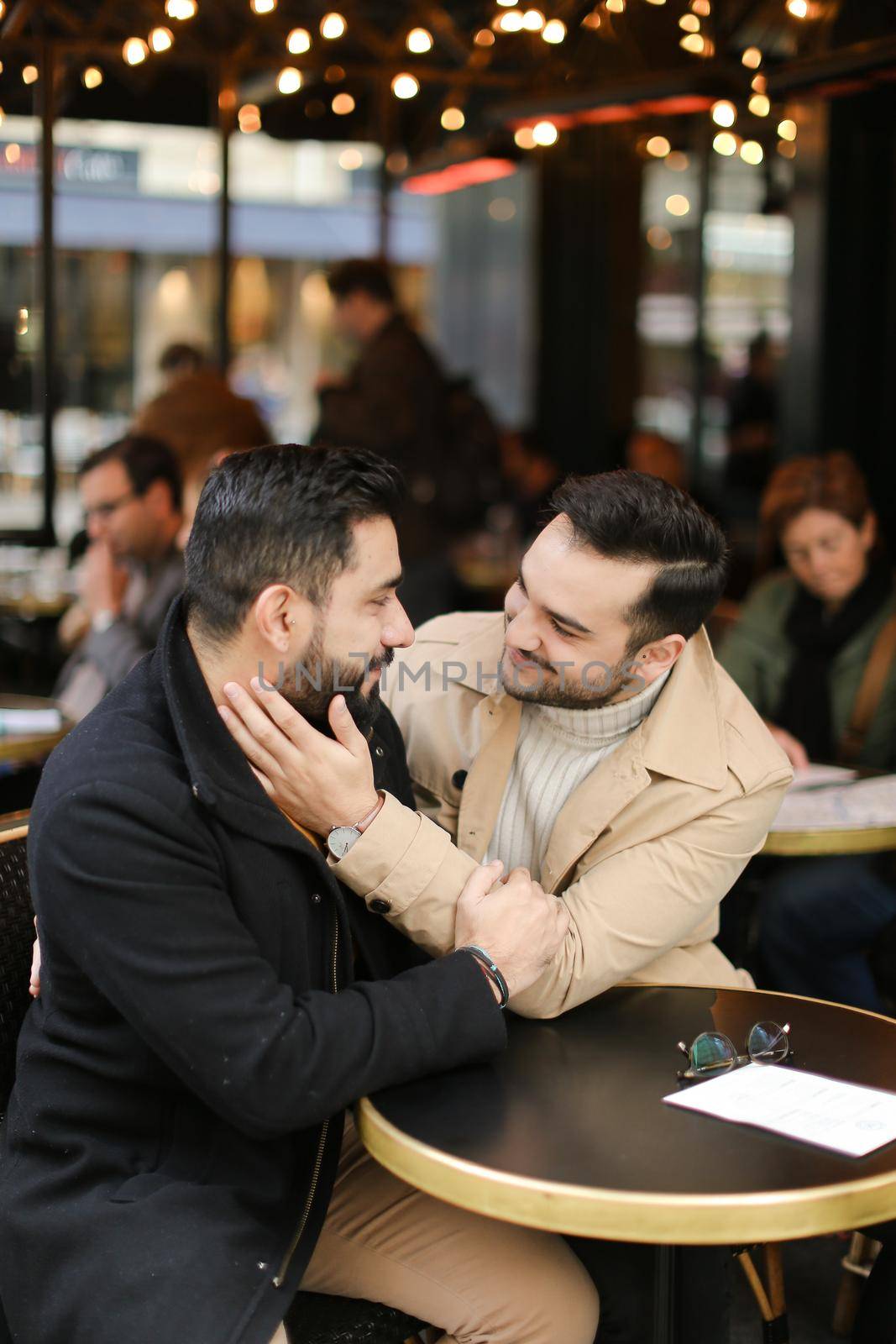 Caucasian european gays sitting at cafe and hugging. by sisterspro