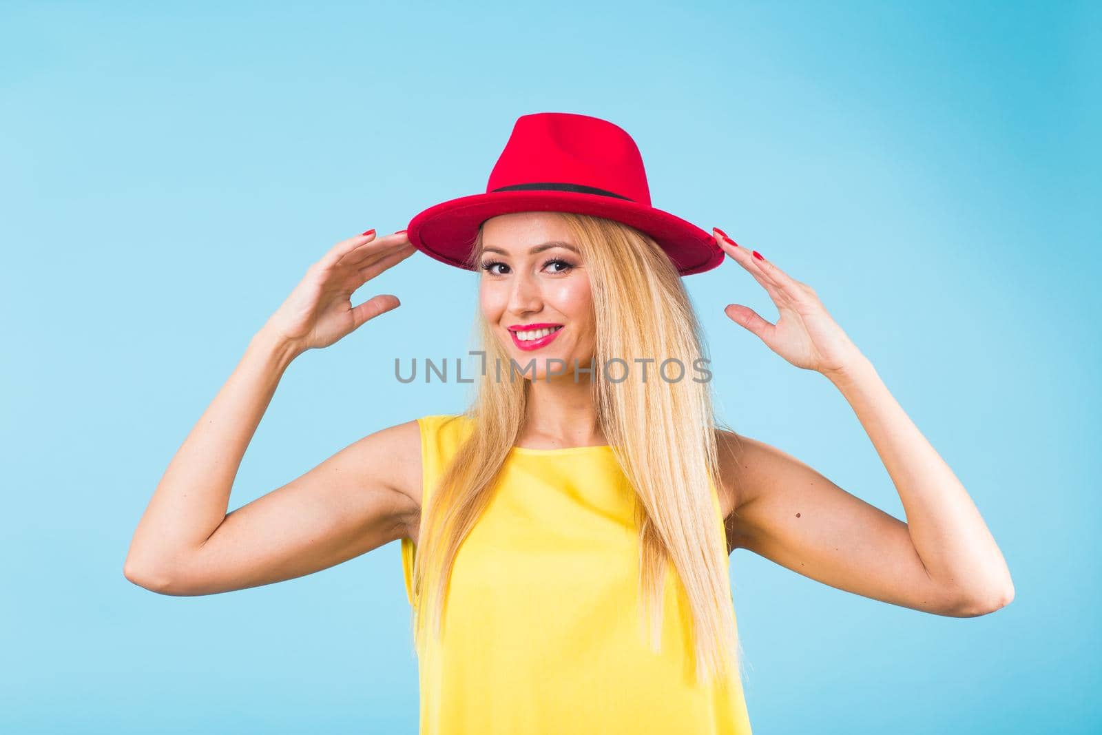 Portrait of smiling blonde woman in fashionable look on blue background. Style, fashion, summer and people concept by Satura86