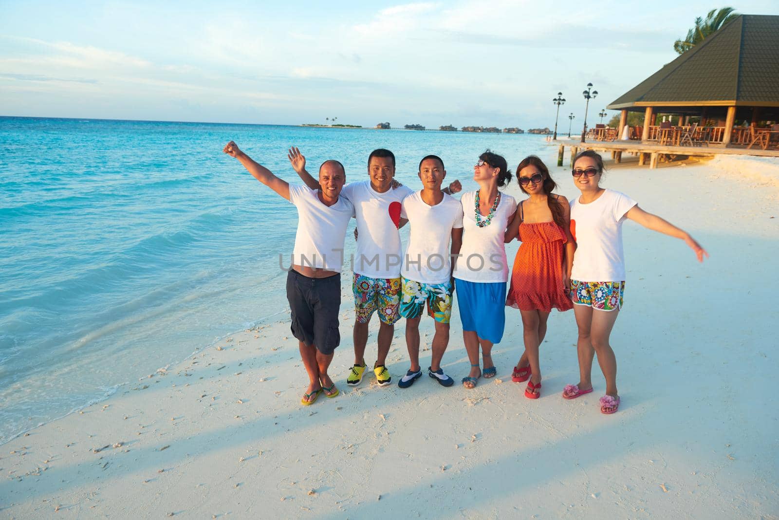 group of friends on beautiful beach by dotshock