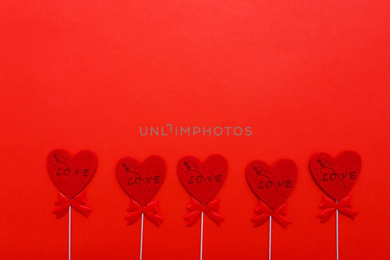 Red hearts on red background for valentines day. Holidays, love and romance by lifesummerlin