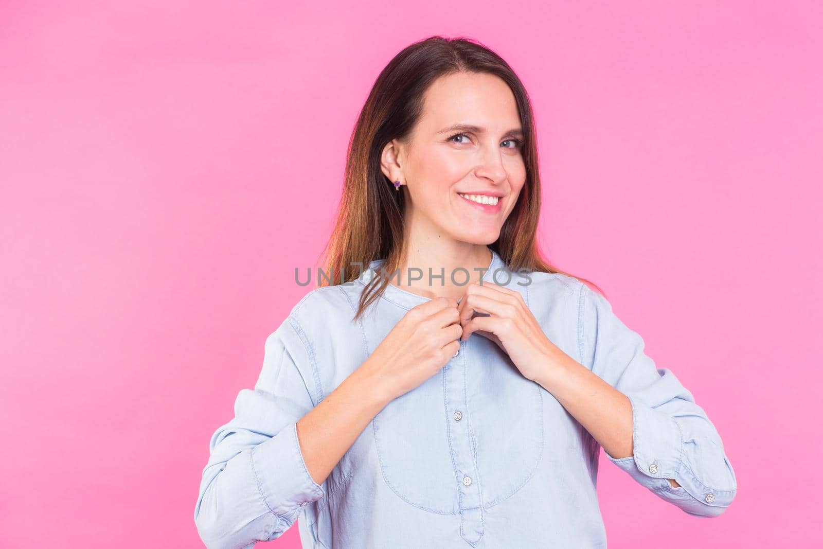 Smiling Woman in shirt posing in studio on pink background by Satura86