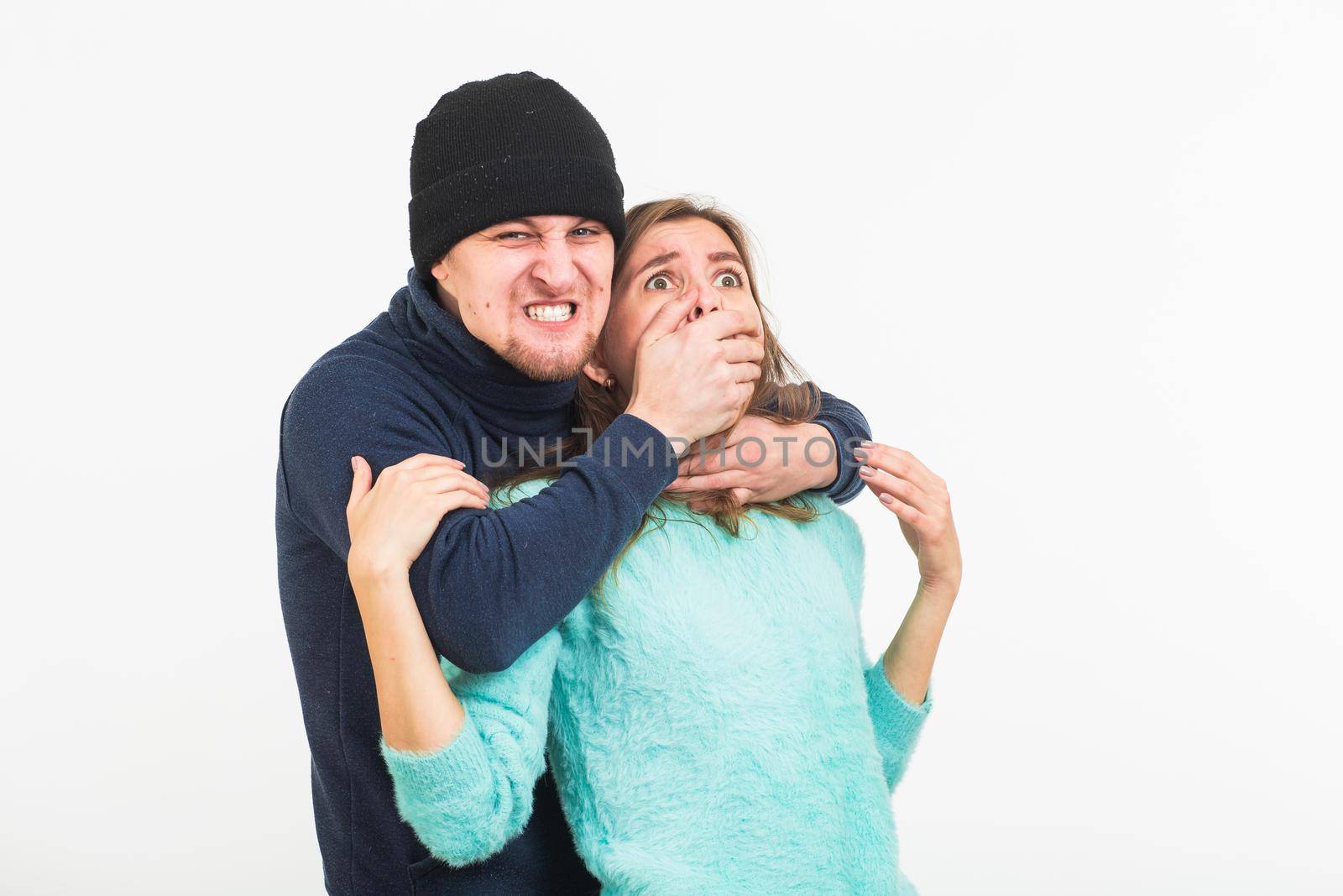 Woman victim of violence and abuse. Criminal man beats a woman on white background by Satura86