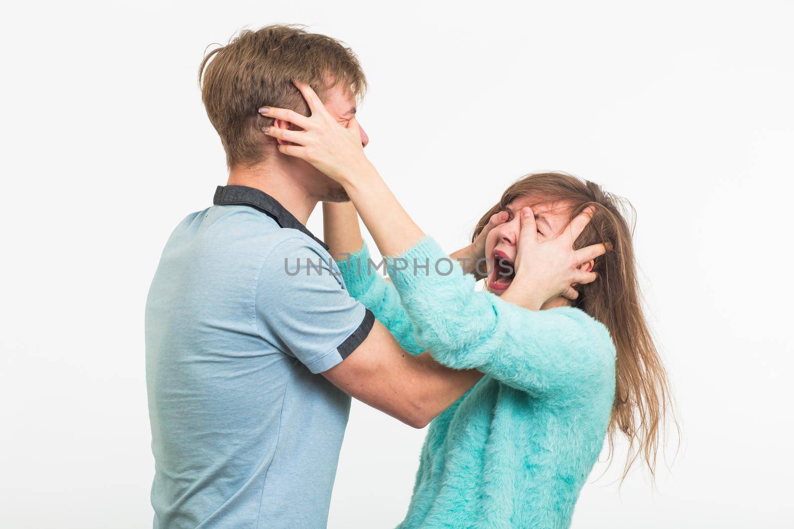 Woman victim of domestic violence and abuse. The quarrel in the family. A man beats a young woman on white background by Satura86