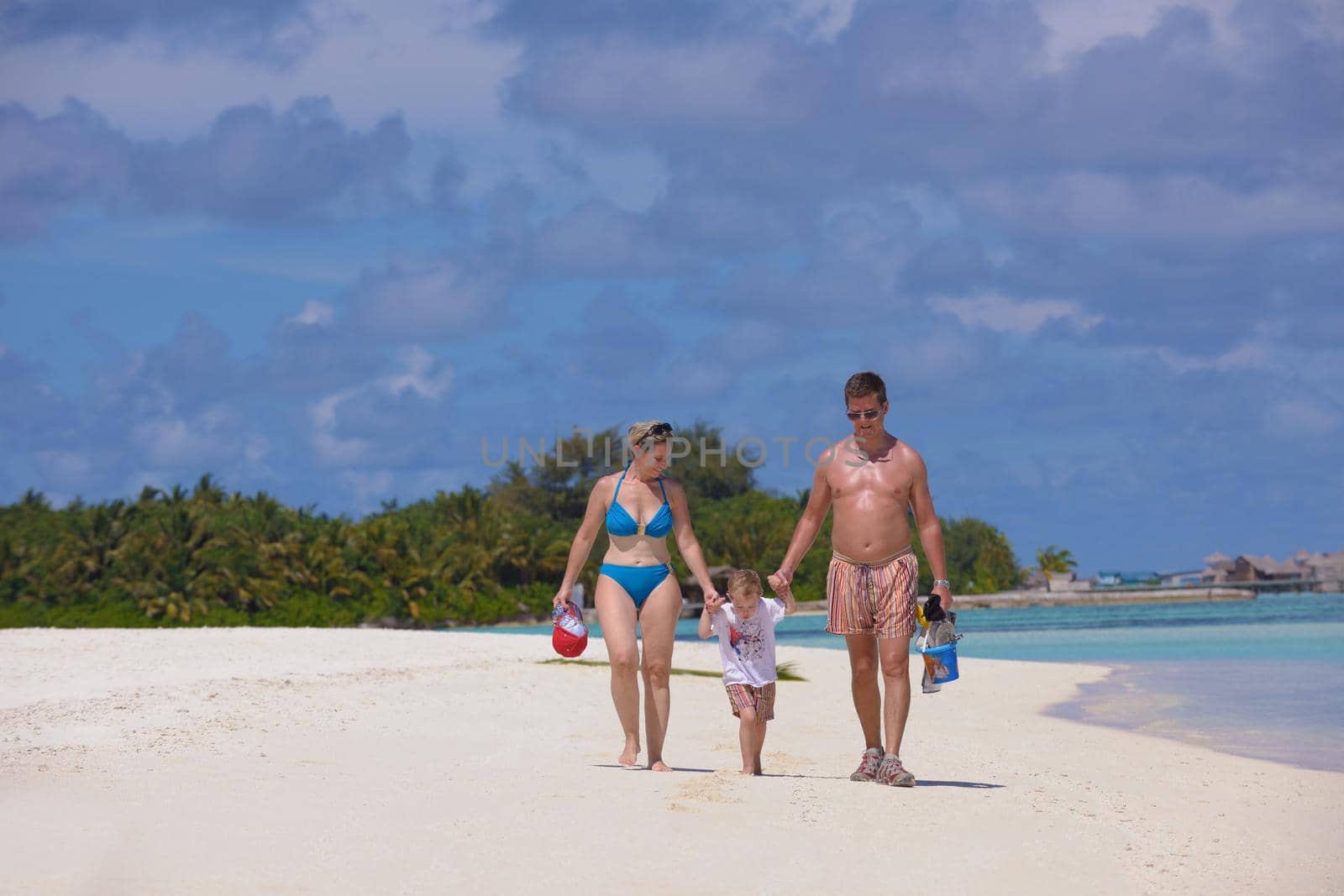 Portrait of a happy family on summer vacation  at beach