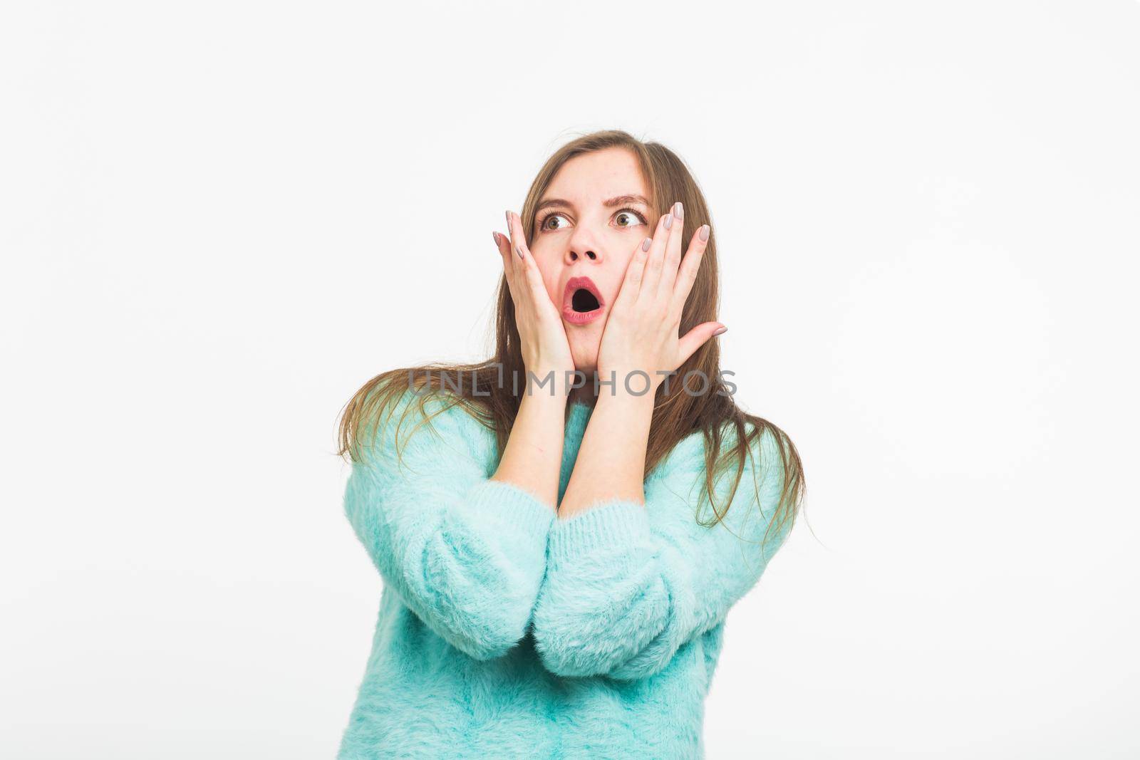 Concerned scared woman on white background in studio