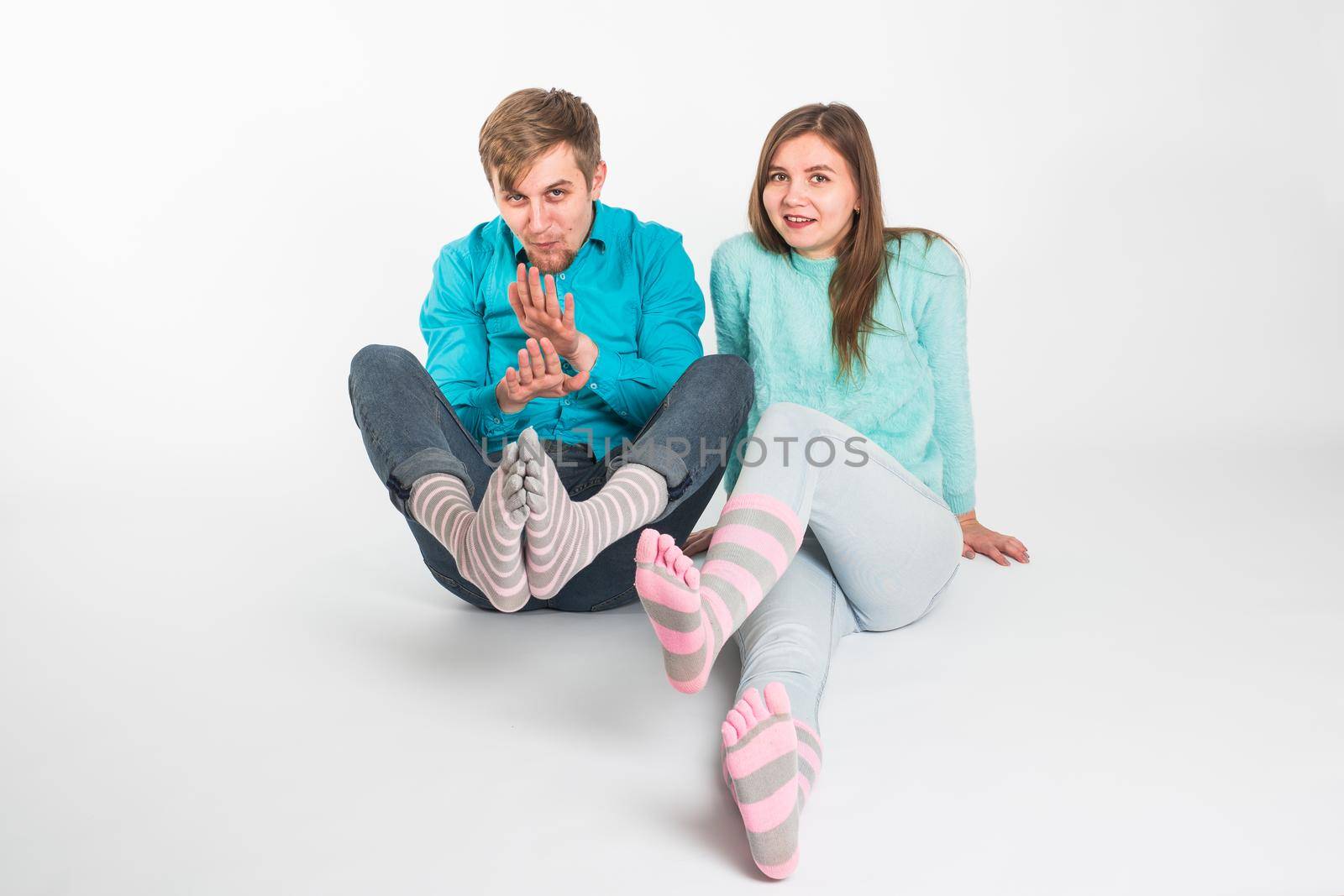 Portrait funny moments of excited couple fooling around to camera on white background. Having fun, weekends and valentines day concept by Satura86