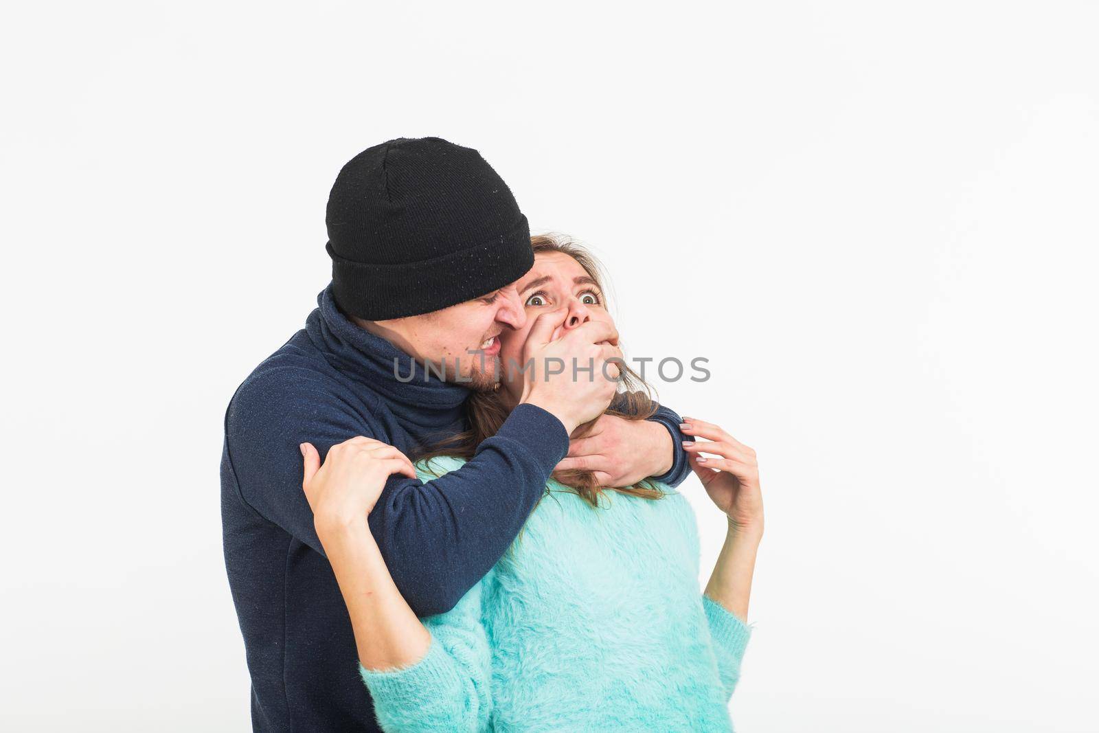 Woman victim of violence and abuse. Criminal man beats a woman on white background by Satura86