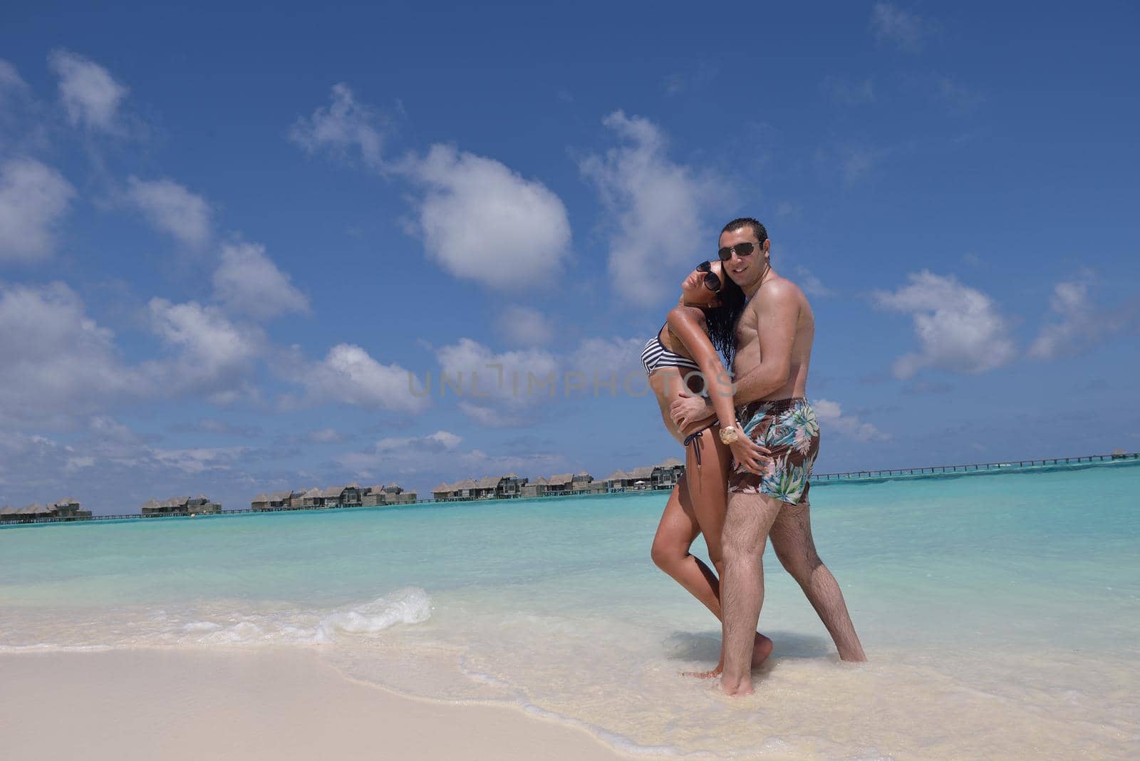 happy young romantic couple in love have fun and relaxing on beautiful beach