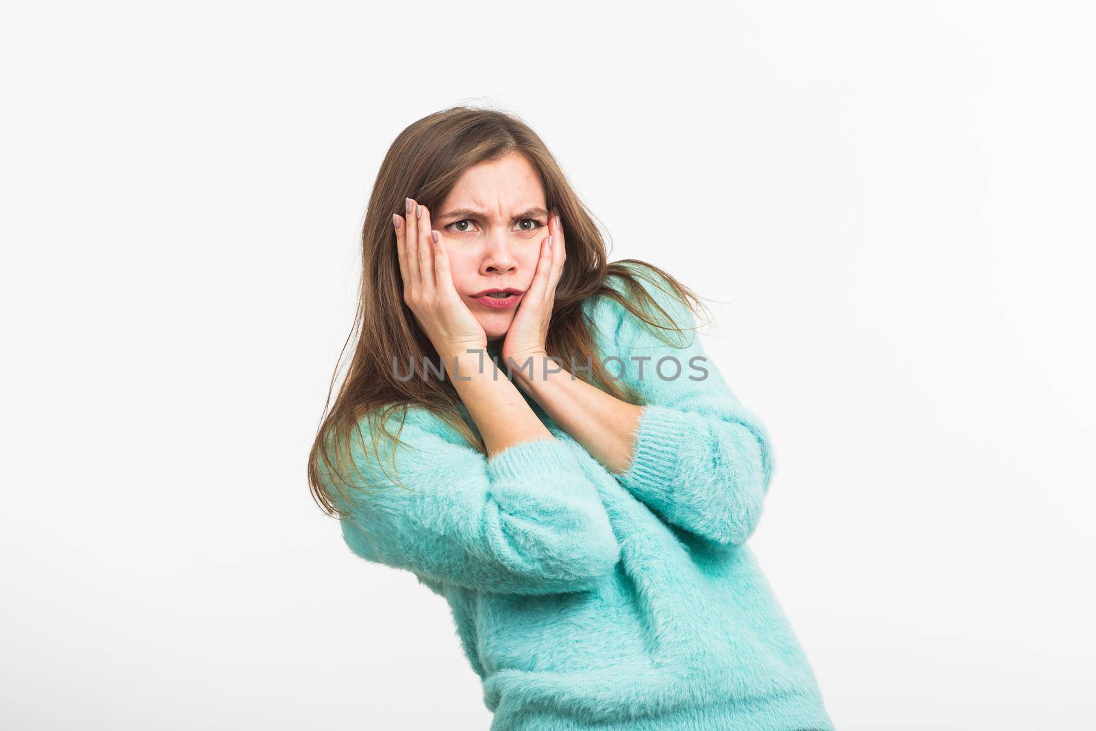 Concerned scared woman on white background in studio