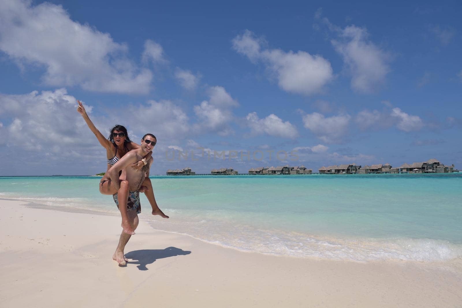 happy young romantic couple in love have fun and relaxing on beautiful beach