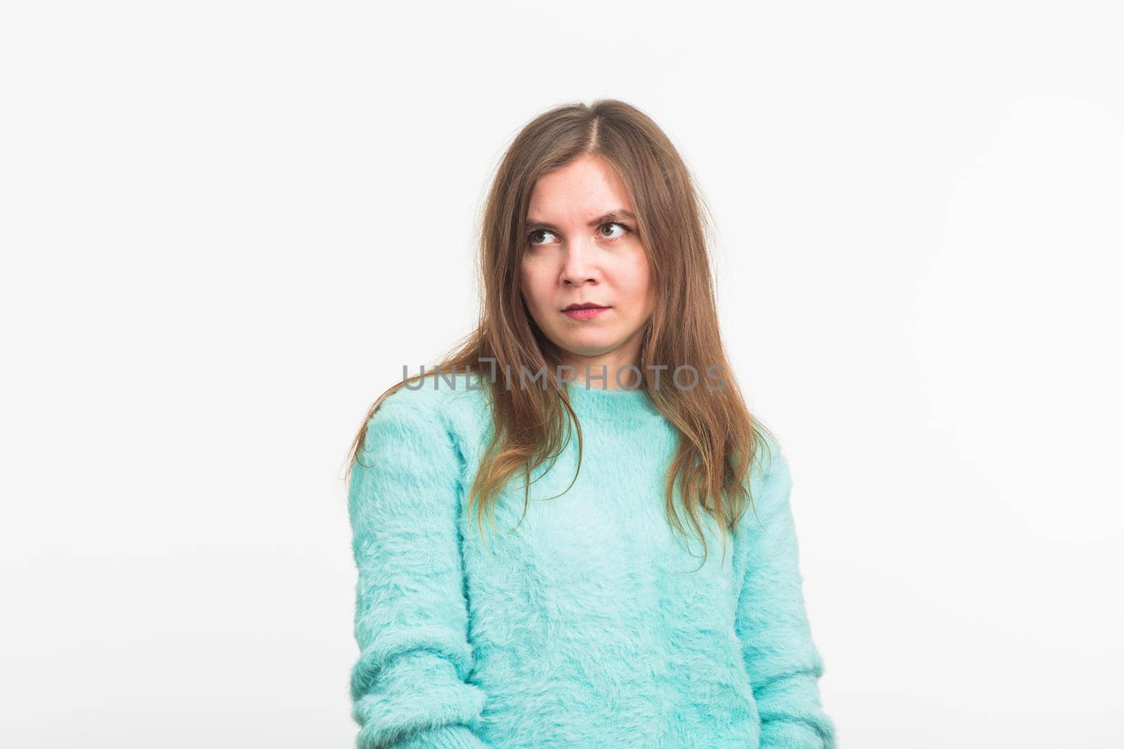 Young woman Looking with disdain on white background