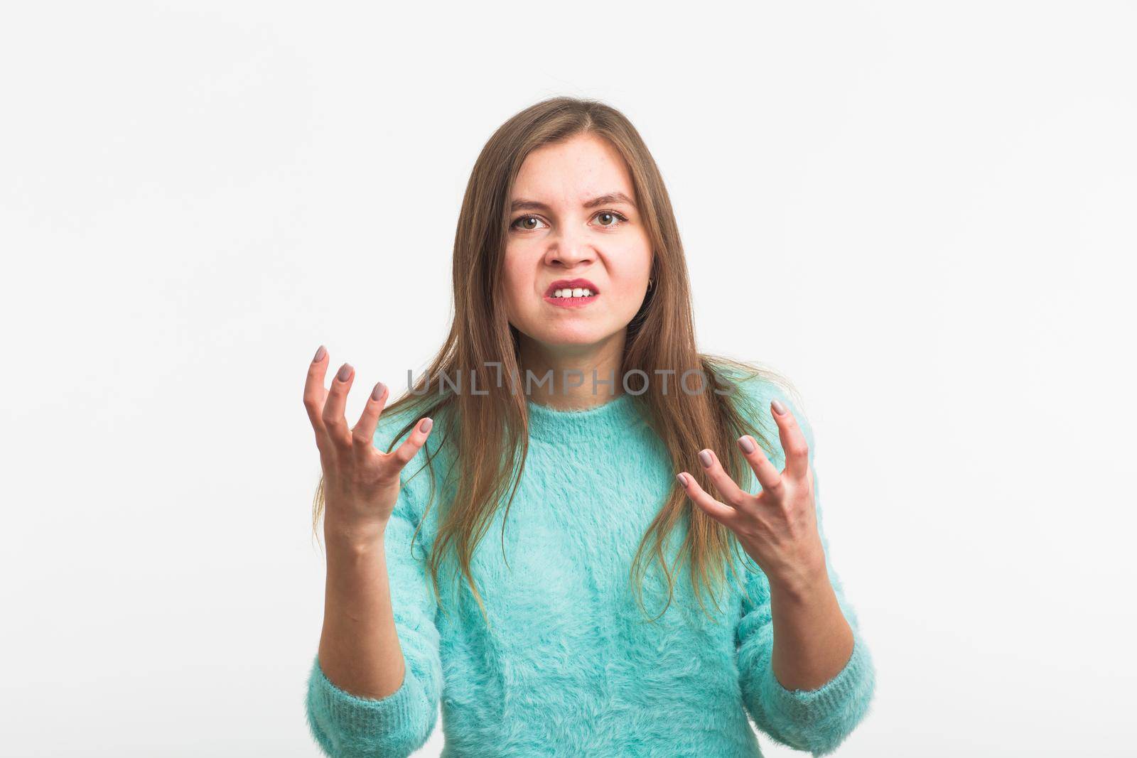 portrait of young angry woman on white background.