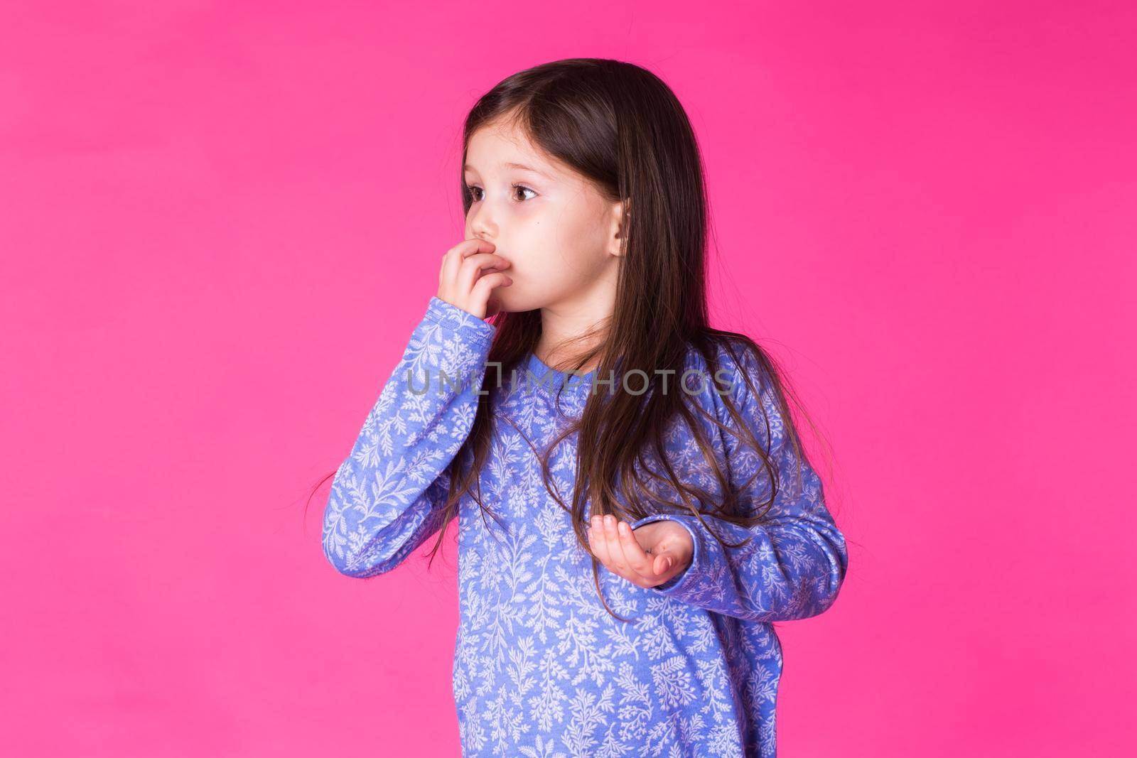 Pretty cute little girl on pink background