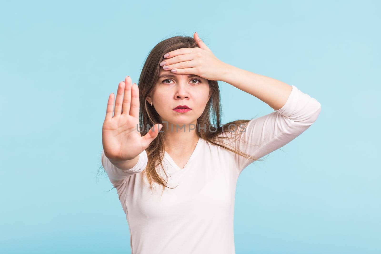 Beautiful woman suffering from acute headache over blue background by Satura86