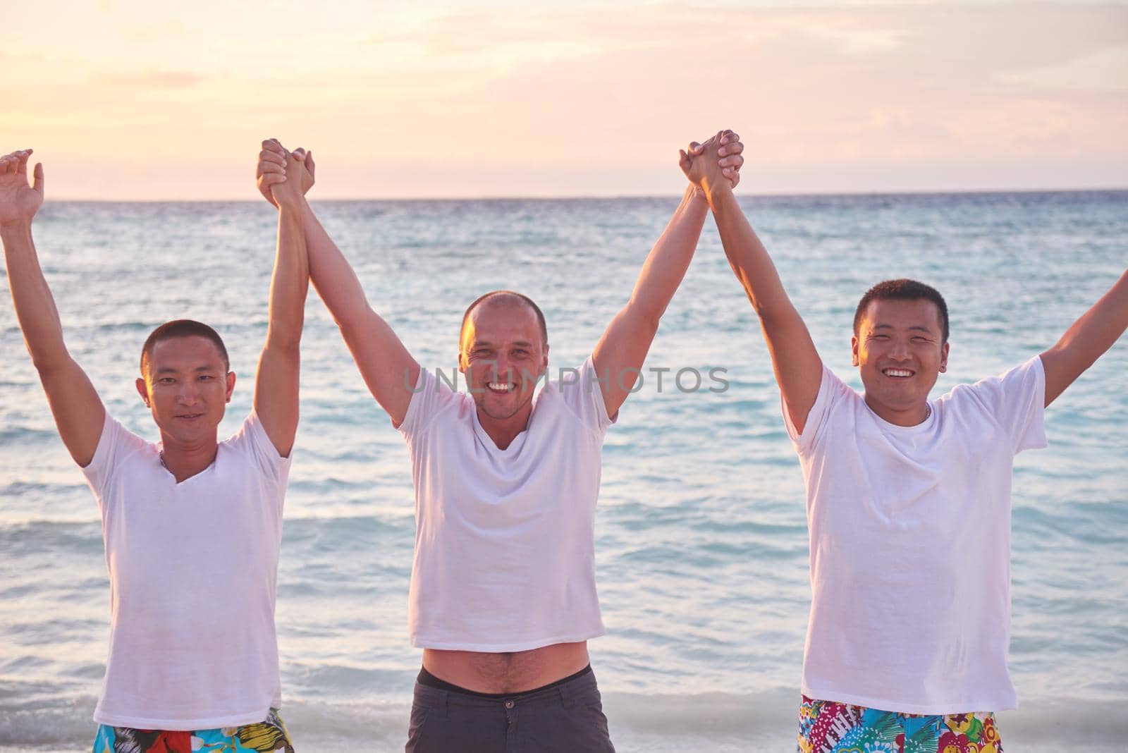 group of friends on beautiful beach by dotshock