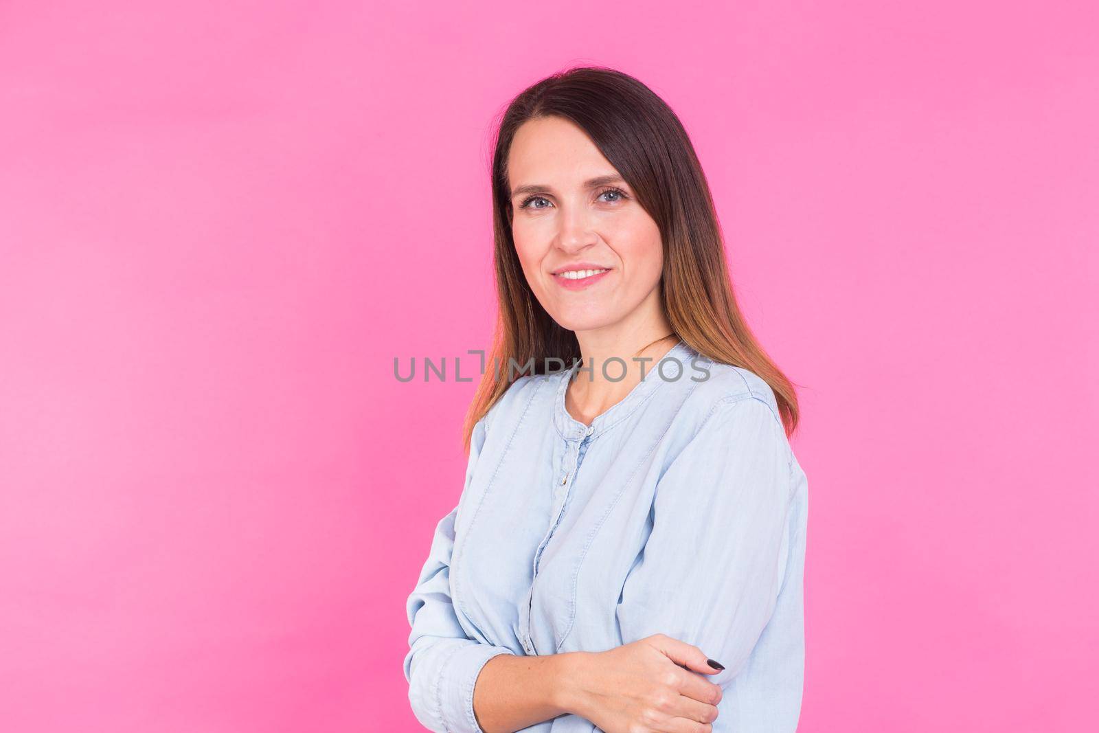 Smiling Woman in shirt posing in studio on pink background by Satura86