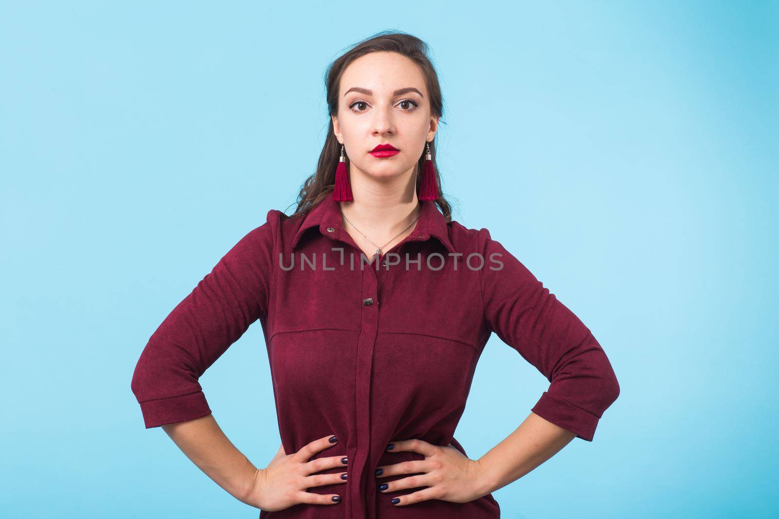 Portrait of young beautiful woman cheerfuly smiling looking at camera. Isolated on pastel blue background. Copy space. by Satura86