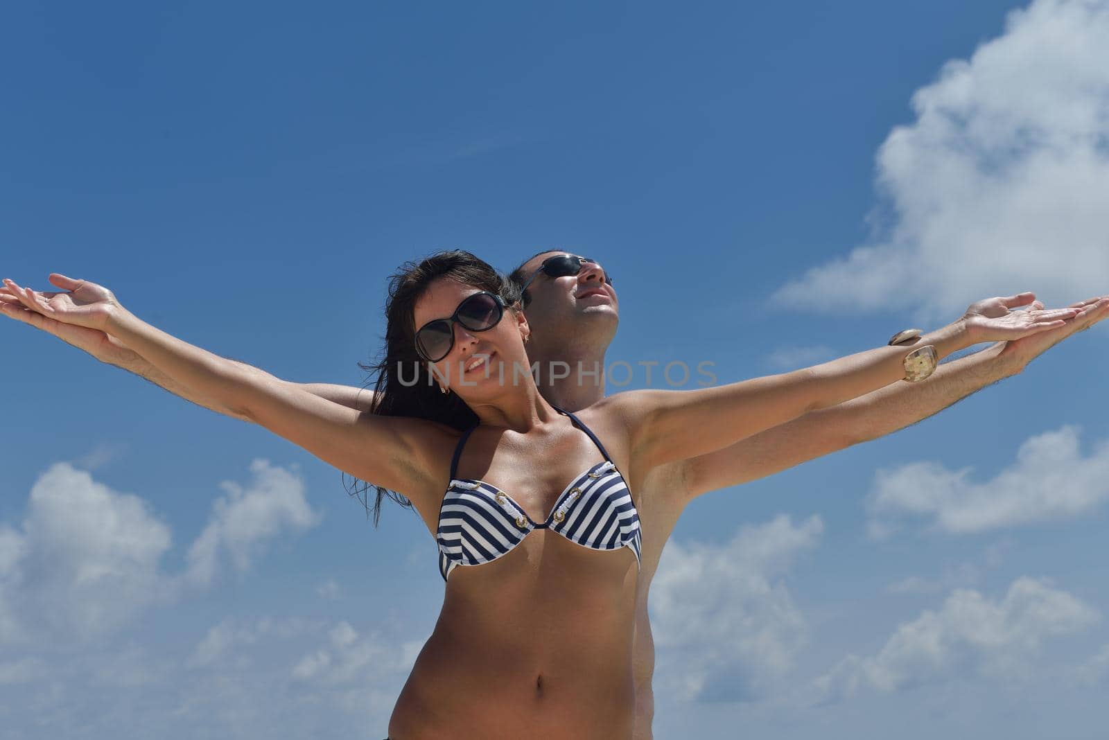 happy young romantic couple in love have fun and relaxing on beautiful beach