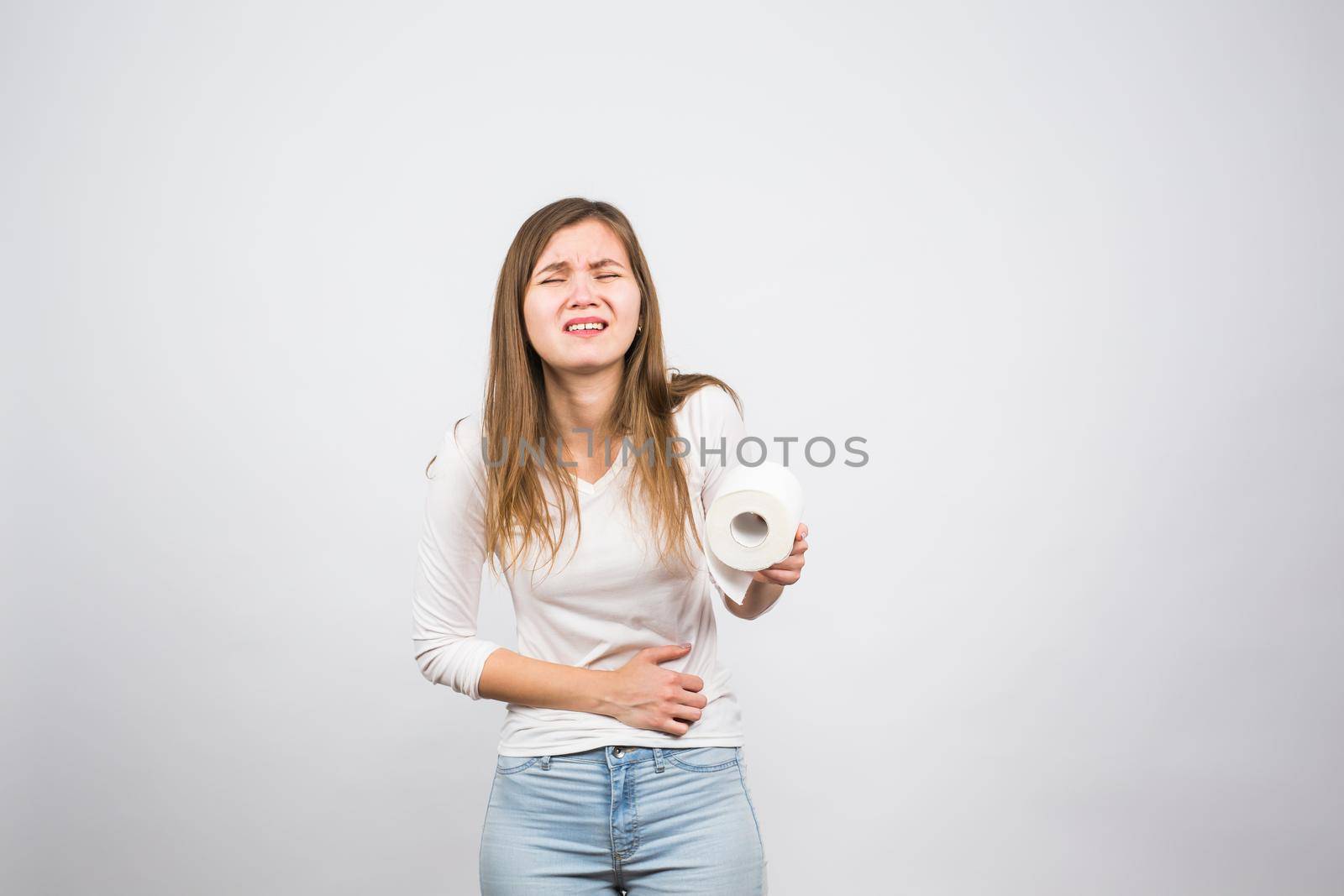 Woman with toilet paper and problems with her digestive system.