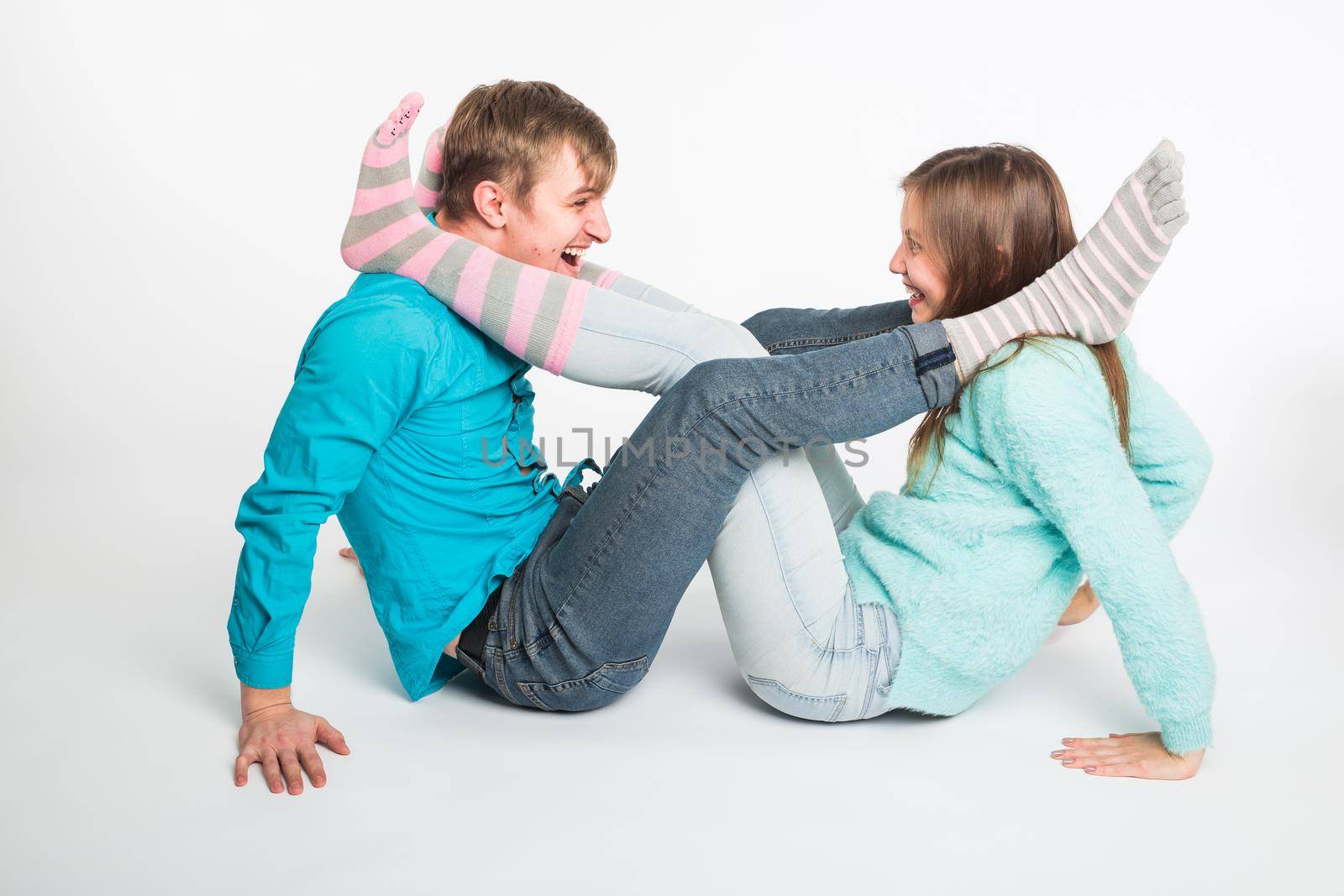 Portrait funny moments of excited couple fooling around to camera on white background. Having fun, weekends and valentines day concept.