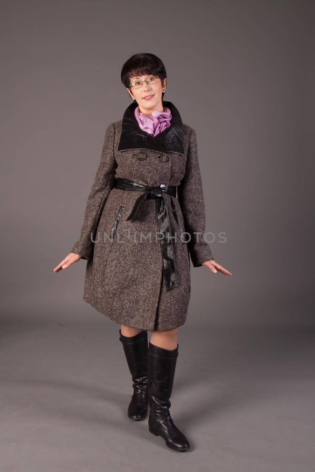 Elegant middle aged woman posing with woolen warm scarf