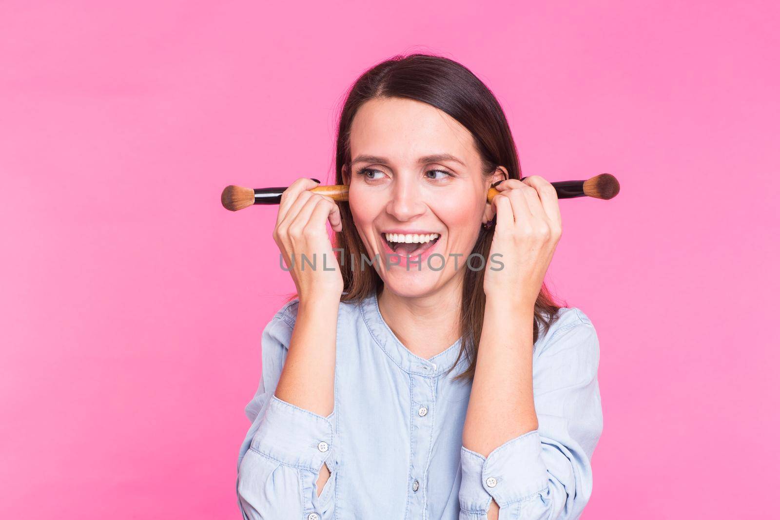 Funny makeup artist with brushes on pink background by Satura86