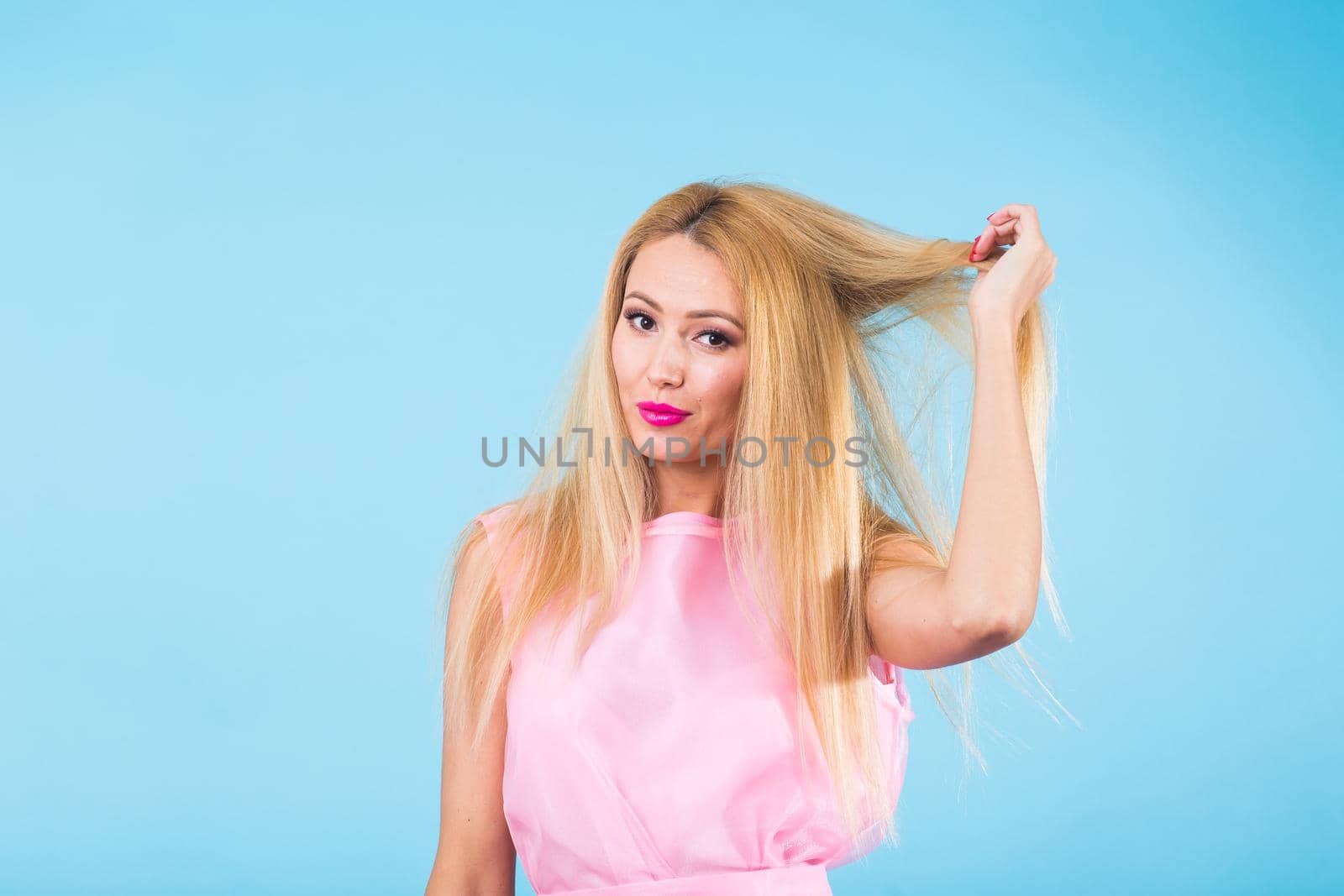 Portrait of smiling blonde woman in fashionable look on blue background. Style, fashion, summer and people concept by Satura86