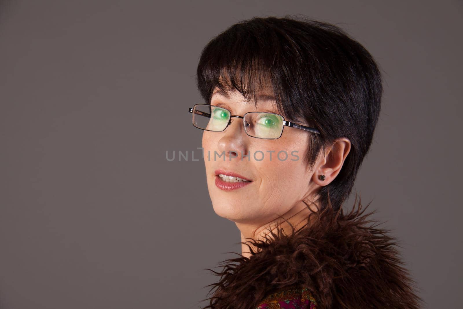 Elegant middle aged woman posing with woolen warm scarf