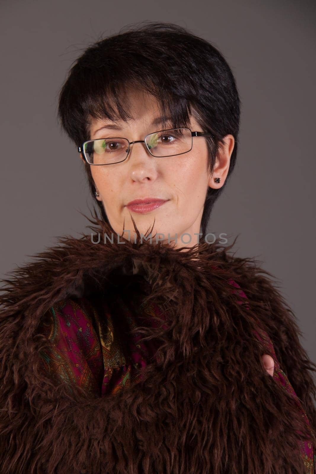 Elegant middle aged woman posing with woolen warm scarf