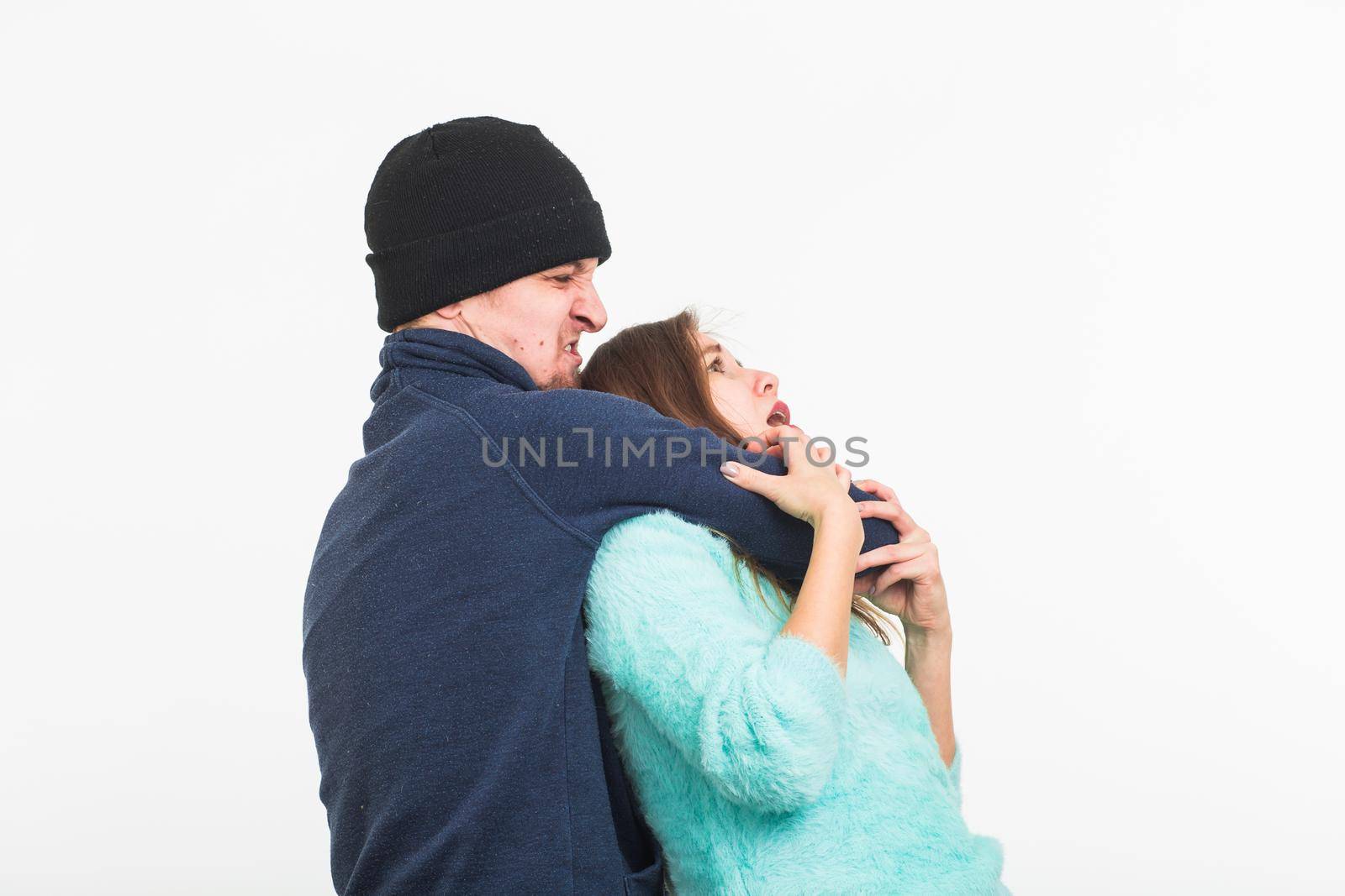 Woman victim of violence and abuse. Criminal man beats a woman on white background by Satura86